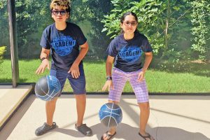 Asia and brother bouncing matching basketballs