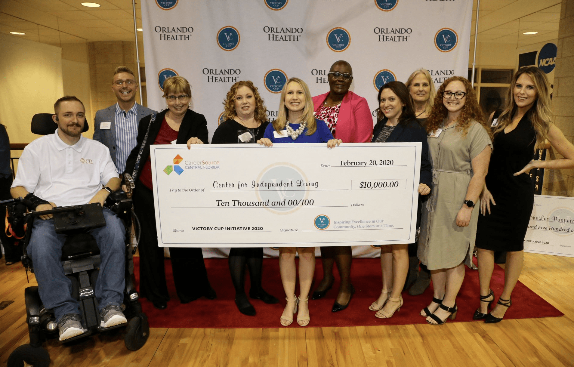 Christopher Pruitt with CIL staff and board members holding a check for $10,000- after receiving third place at the 2020 Victory Cup Initiative competition. 