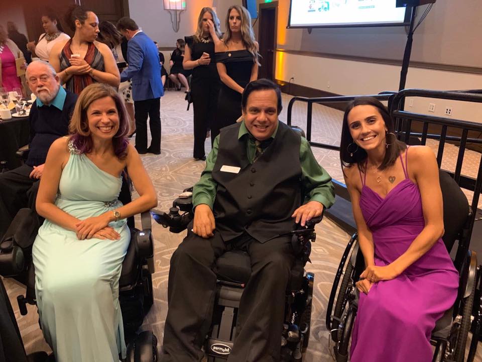 Sylvia Longmire in wheelchair (left), Hector Del Valle in wheelchair (middle), and Amanda Perla Jereczek in wheelchair (right) wearing formal attire and smiling.