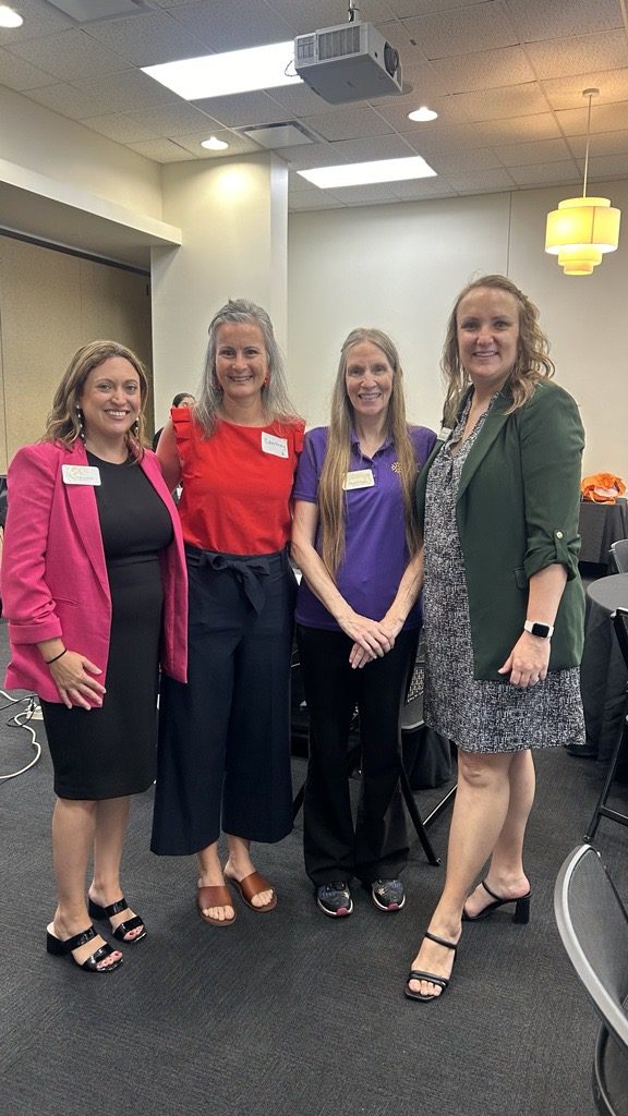 Four women dressed in business attire